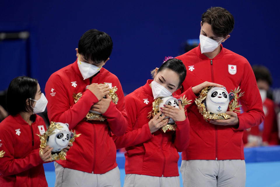 Bronze medalists, Team Japan, pose during the victory ceremony after the team event in the figure skating competition at the 2022 Winter Olympics, Monday, Feb. 7, 2022, in Beijing. (AP Photo/Natacha Pisarenko)