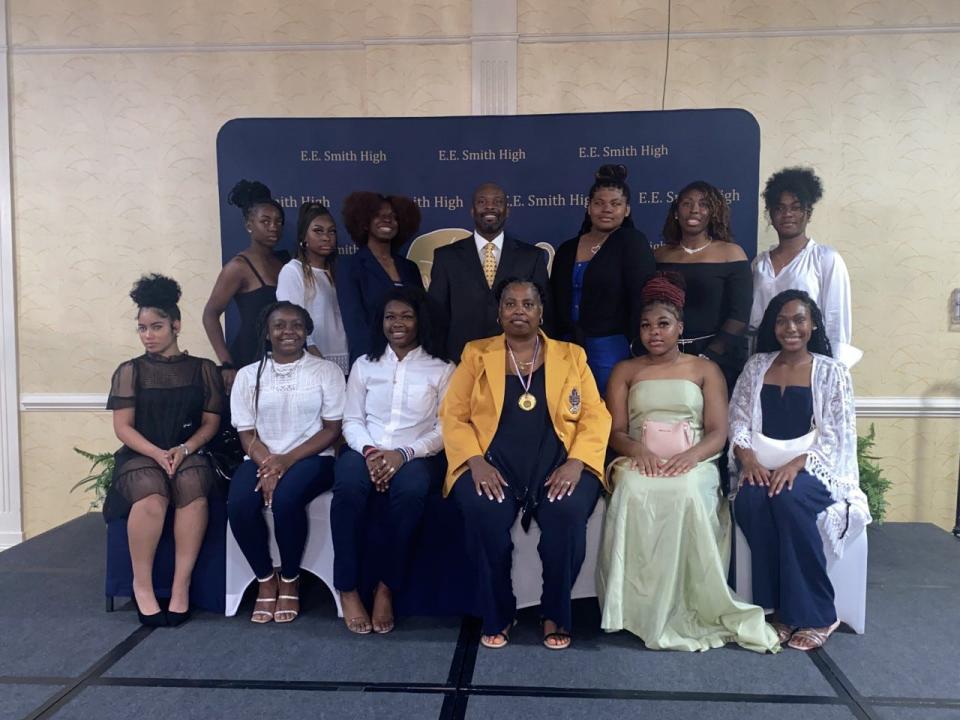 LaTanya Hardy (pictured in middle) poses with the current E.E. Smith High School girl's basketball team. Hardy, a 1981 graduate, came back to the school to coach basketball and volleyball. She was one of the honorees of the school's inaugural Sports Hall of Fame induction ceremony Sunday May 29, 2022.