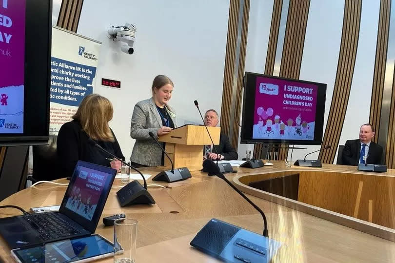 Julia speaking in front of Jenni Minto MSP, Minister for Public Health and Women’s Health and Bob Doris, MSP