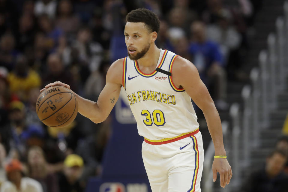 Golden State Warriors guard Stephen Curry (30) dribbles the ball up the court against the Toronto Raptors during the second half of an NBA basketball game in San Francisco, Thursday, March 5, 2020. (AP Photo/Jeff Chiu)