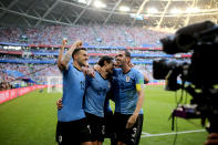 <p>Uruguay celebrate their third goal – and their third win </p>