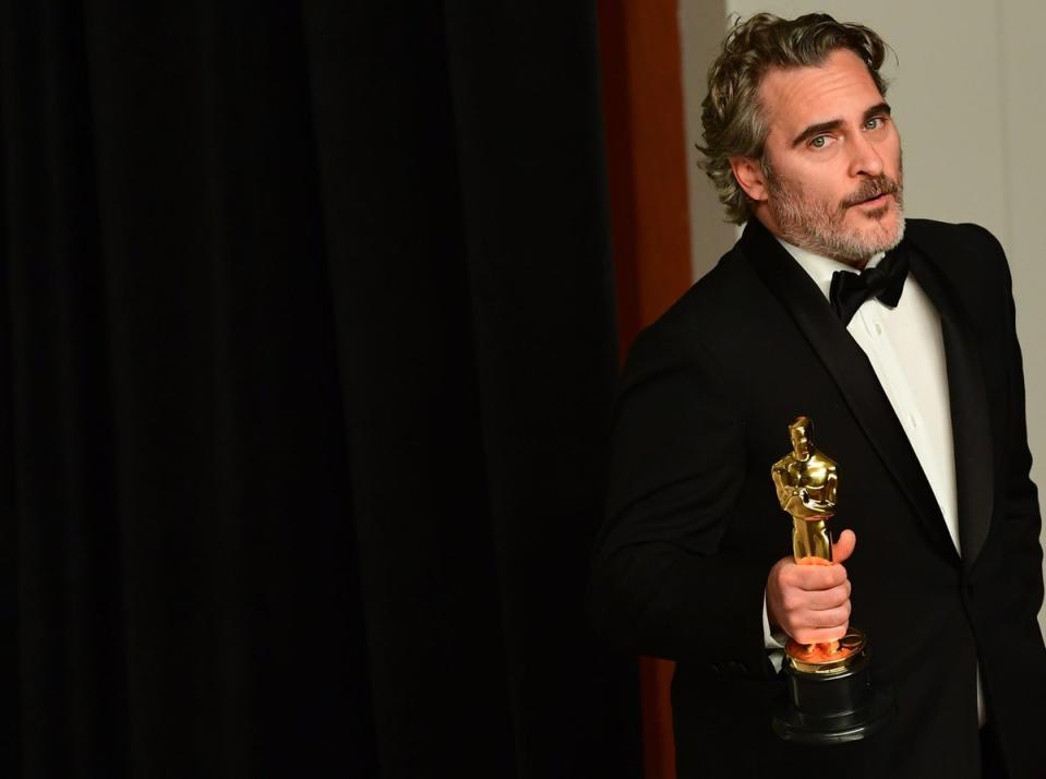 Joaquin Phoenix poses in the press room with the Oscar for Best Actor for ‘Joker’ in 2019 (AFP via Getty Images)