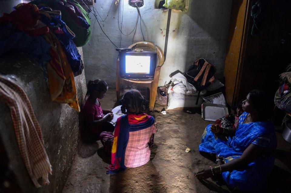 Government Primary School students follow the e-education classes telecast on the T-SAT Network and Doordharshan TV network channels as their mum watches, at their home in Nagireddypally village of Siddipet District, near Hyderabad, September 1, 2020. / Credit: NOAH SEELAM/AFP/Getty