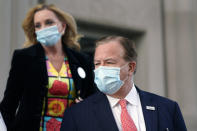 Mark and Patricia McCloskey leave following a court hearing Wednesday, Oct. 14, 2020, in St. Louis. The McCloskeys have pleaded not guilty to two felony charges, unlawful use of a weapon and tampering with evidence, after been seen waving guns at protesters marching on their private street this past summer. (AP Photo/Jeff Roberson)