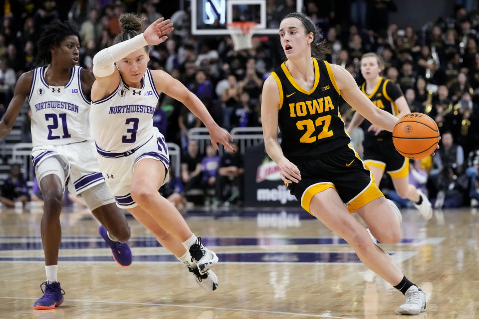 Iowa guard Caitlin Clark (22) drives as Northwestern guard Maggie Pina guards during the first half of an NCAA college basketball game in Evanston, Ill., Wednesday, Jan. 31, 2024. (AP Photo/Nam Y. Huh)