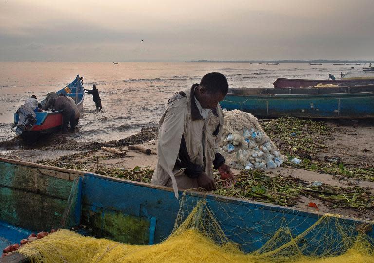 Fisherman preparing his nets for the next fishing expedition at Kasensero's fishermen landing site, on the shores of the Lake Victoria in Uganda on February 21, 2014