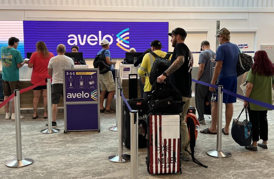 Air travelers line up to catch a departing nonstop flight on Avelo Airlines from Daytona Beach International Airport to New Haven, Connecticut, on Sept. 14, 2023.