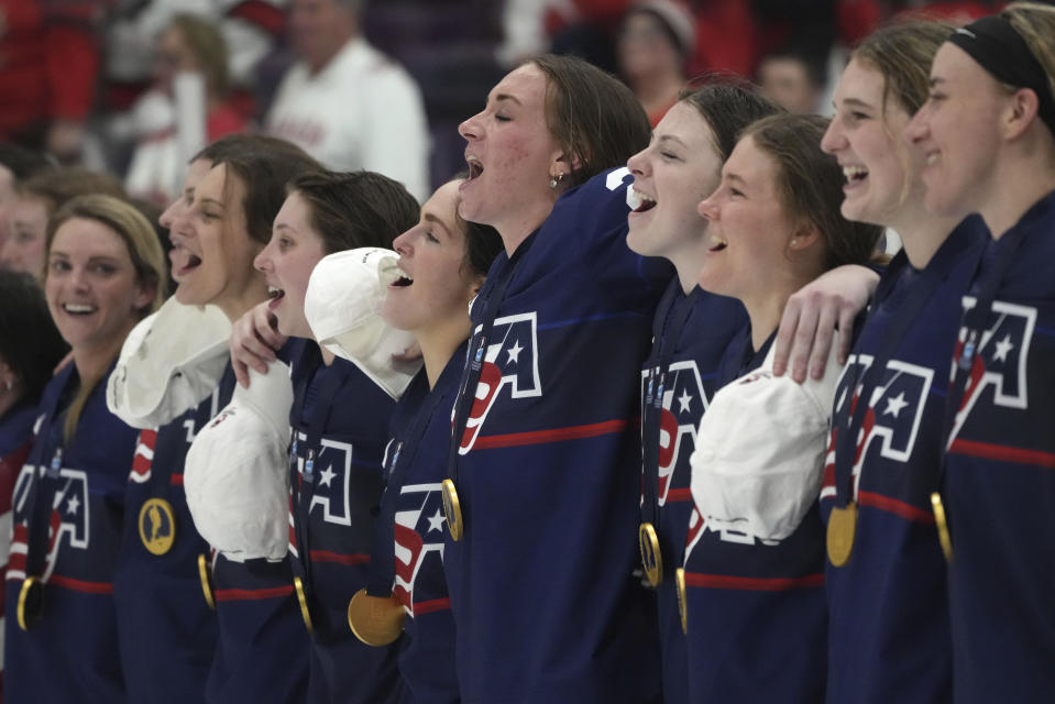 United States players sing along with their national anthem after their goal medal victory against Canada at women's world hockey championships in Brampton, Ontario, Sunday, April 16, 2023. (Nathan Denette/The Canadian Press via AP)