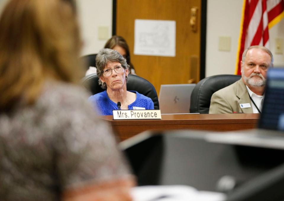 Laura Mullins, president of the Springfield National Education Association, addressed the school board April 9 as board members Susan Provance and Steve Makoski listen.