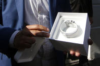 A customer opens the package containing his Apple Watch after buying it at a store in Paris, France, April 24, 2015. REUTERS/Benoit Tessier