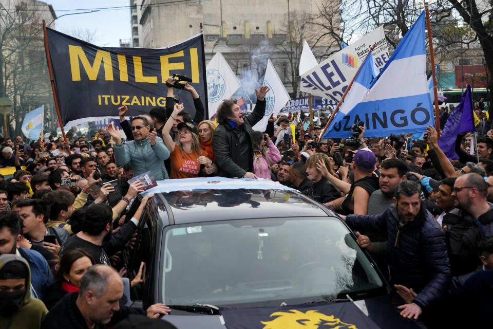 Presidential hopeful of the Liberty Advances coalition Javier Milei, center, waves during a campaign event in La Plata, Argentina, Tuesday, Sept. 12, 2023. General elections are set in Argentina for Oct. 22. (AP Photo/Natacha Pisarenko)