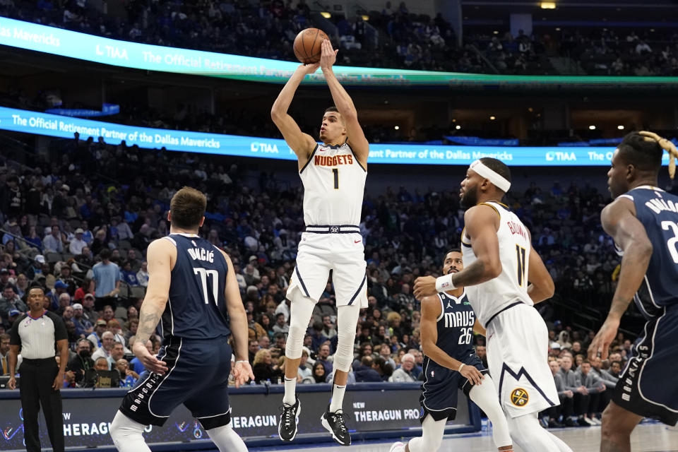 Denver Nuggets forward Michael Porter Jr. (1) shoots over Dallas Mavericks guard Luka Doncic (77) during second half of an NBA basketball game in Dallas, Sunday, Nov. 20, 2022. (AP Photo/LM Otero)