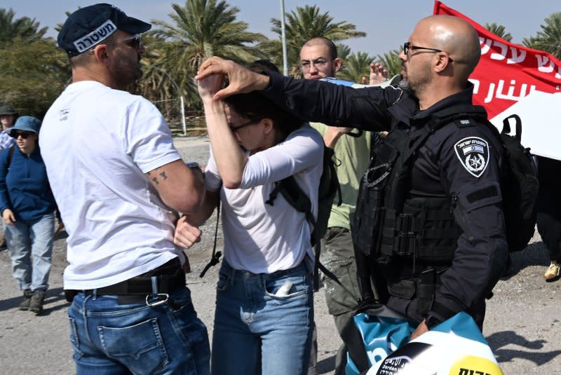 Israeli security forces force a poster from a woman at a protest of Israelis and Palestinians at the Almog Junction, south Jordan Valley near Jericho, West Bank, on Friday. Texas A&M University said it plans to shut down its Qatar campus over the next four years due to unrest in the region. Photo by Debbie Hill/UPI