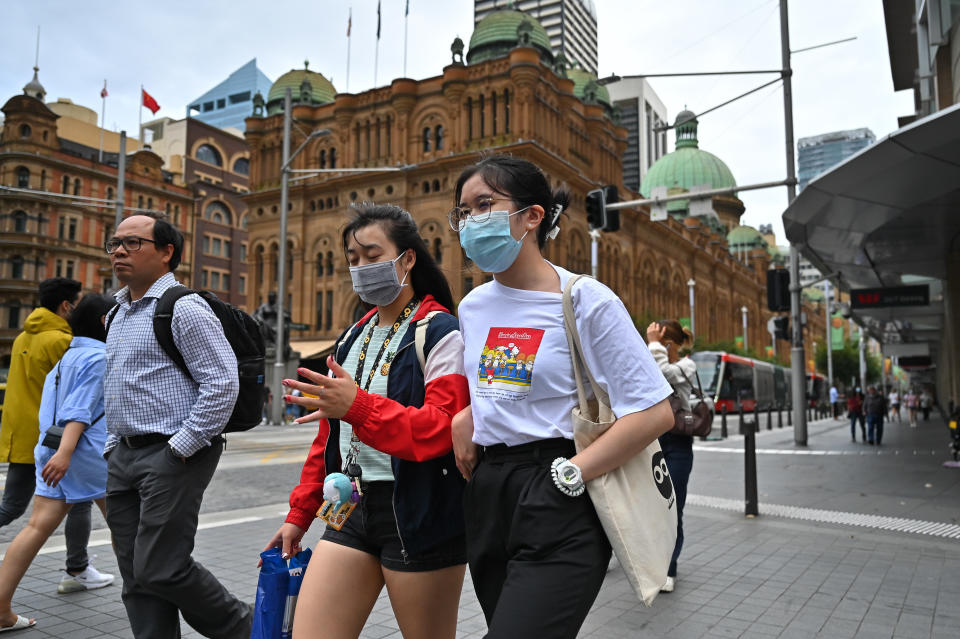 People are seen wearing masks in Sydney on January 25, 2022, as Australia continues to battle a Covid outbreak.