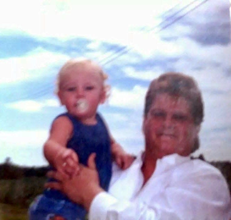 Brian Scott Dutcher Sr. of Sebewaing holds his son Cody Kellior in this family photo from 1987. Dutcher died in 2002 of a massive infection in his brain that went undetected on an initial CT scan.