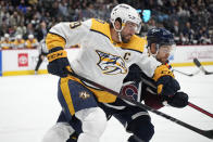 Nashville Predators defenseman Roman Josi, front, collides with Colorado Avalanche left wing Tyson Jost in the first period of an NHL hockey game Saturday, Nov. 27, 2021, in Denver. (AP Photo/David Zalubowski)