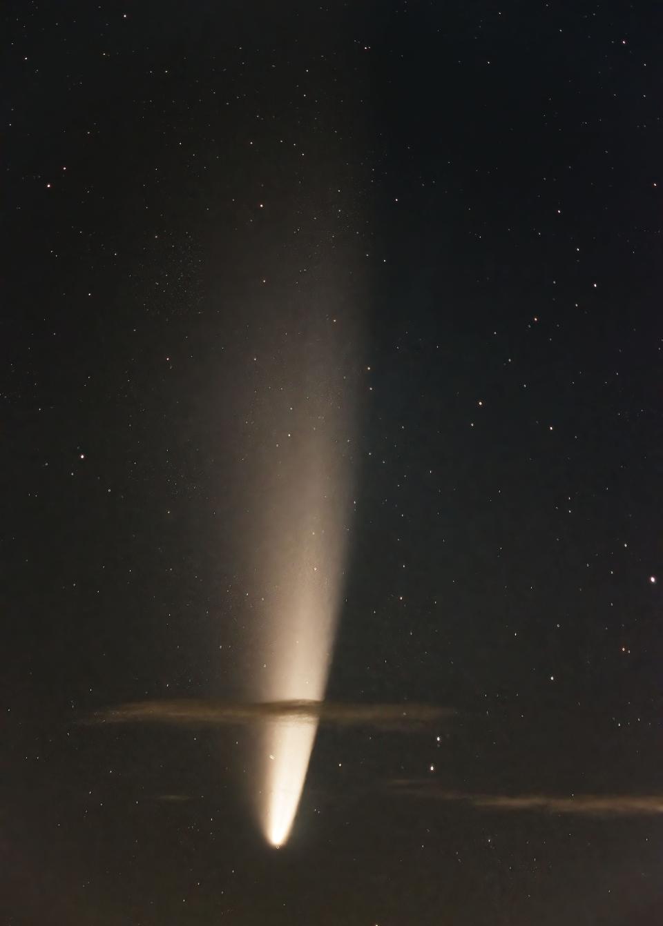 Although not considered a bright comet compared to those seen during the 1990s, Comet NEOWISE, shown here rising behind some foreground clouds July 10, 2020, was an interesting comet for amateur astronomers.