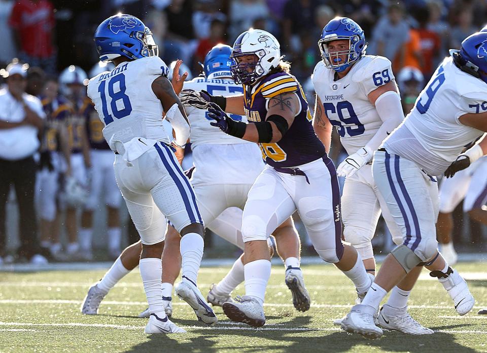 Ashland University's Kristian Gehrisch (98) pressures Notre Dame College's Chris Brimm (18) during college football action at Jack Miller Stadium, Thursday, Sept. 1, 2022. TOM E. PUSKAR/ASHLAND TIMES-GAZETTE