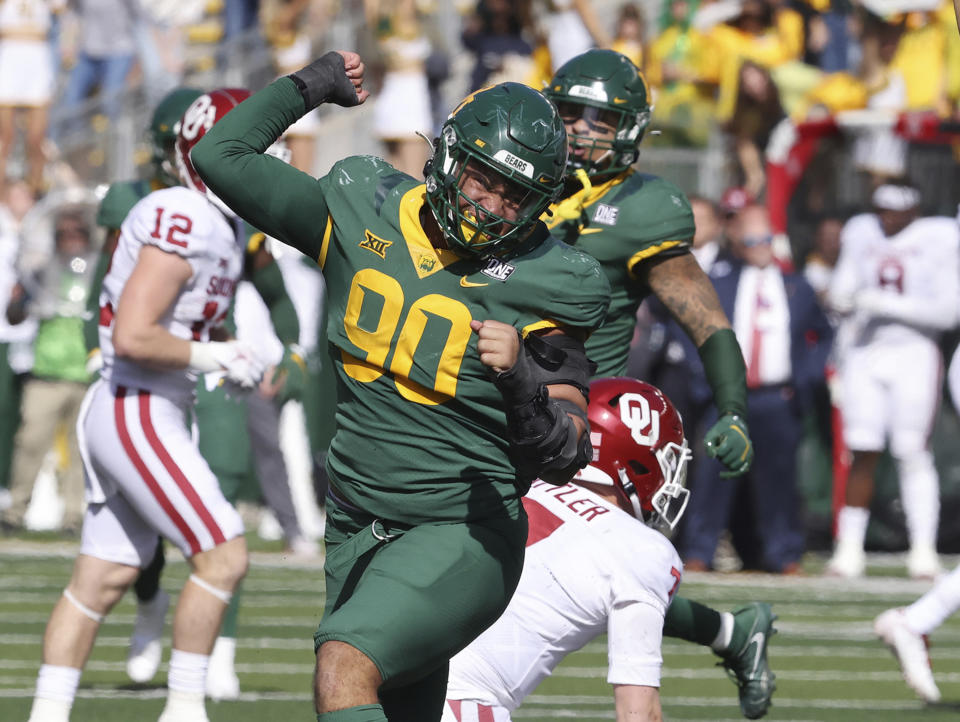 Baylor defensive lineman TJ Franklin reacts to his tackle on Oklahoma quarterback Spencer Rattler in the first second half of an NCAA college football game, Saturday Nov. 13, 2021, in Waco, Texas. (Rod Aydelotte/Waco Tribune-Herald via AP)