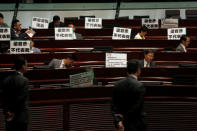 Pro-democracy protesters display placards which read "Andrew Leung does not represent me", referring to the Legislative Council president, during a demonstration inside the council's chamber in Hong Kong, China October 26, 2016. REUTERS/Bobby Yip