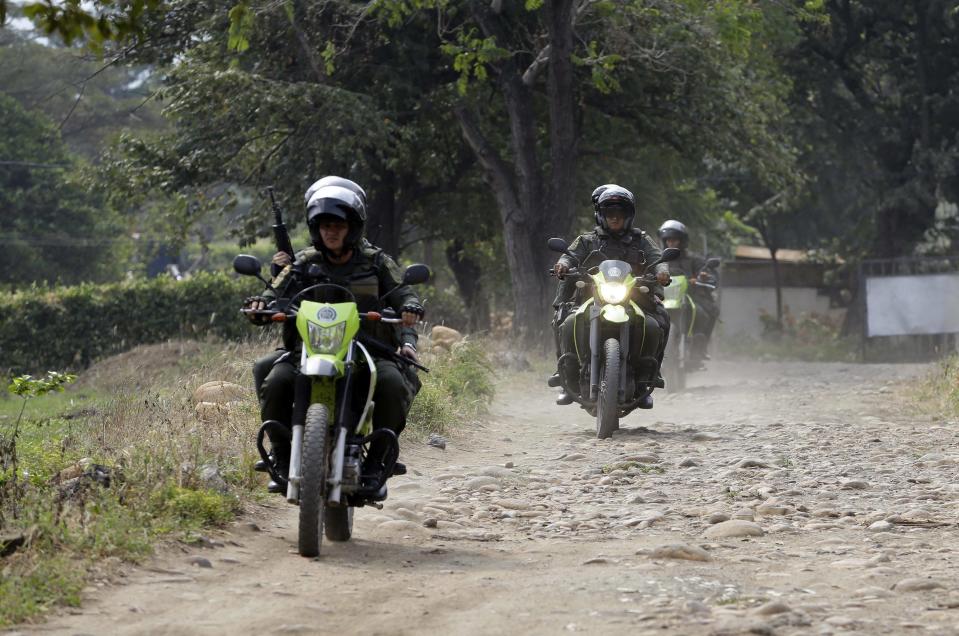 Colombian police patrol near the Tienditas International Bridge that connects Colombia and Venezuela, on the outskirts of Cucuta, Colombia, Wednesday, Feb. 6, 2019. Venezuelan authorities attempting to block humanitarian aid entering from Colombia have barricaded the key border crossing. (AP Photo/Fernando Vergara)