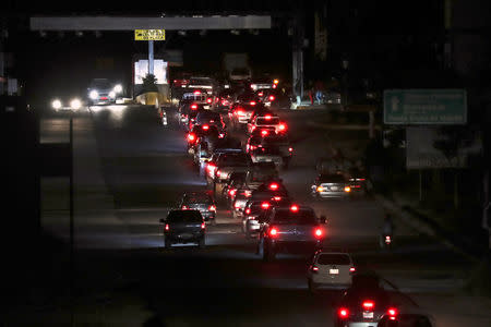 Vehicles are pictured as they cross the border into Venezuela, as seen from the Brazilian city of Pacaraima, Roraima state, Brazil February 21, 2019. REUTERS/Ricardo Moraes