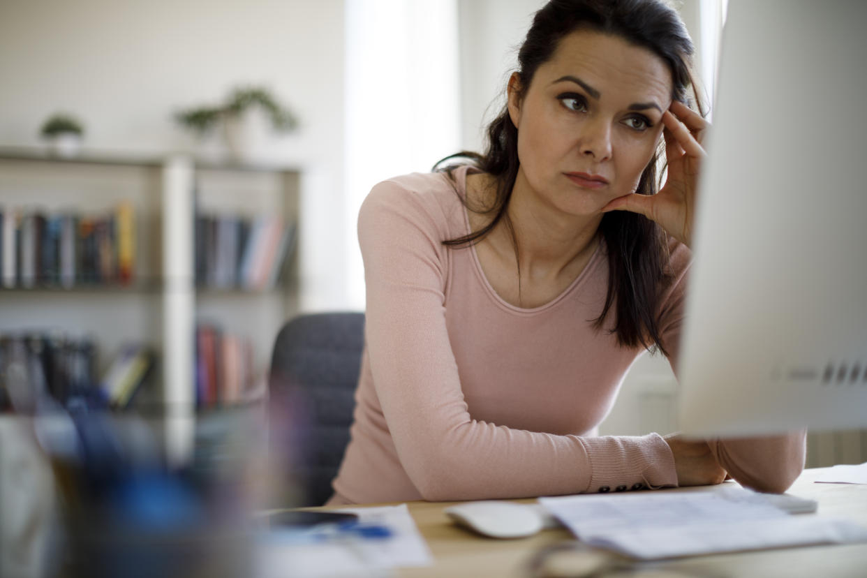 Worried businesswoman looking at computer screen