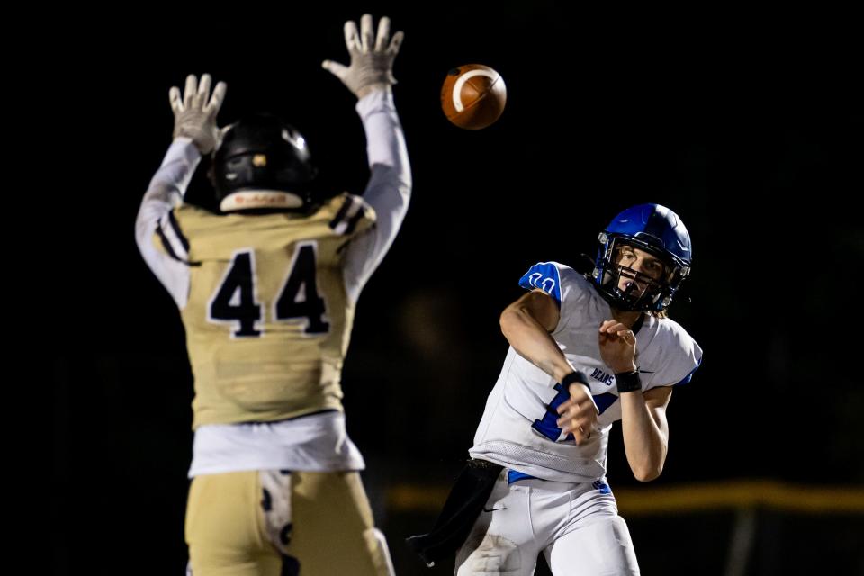 Bartram Trail Bears quarterback Riley Trujillo (11) throws the ball under pressure from Buchholz Bobcats outside linebacker Aiden Brake (44) during the first half in the Regional Finals of the 2023 FHSAA Football State Championships at Citizens Field in Gainesville, FL on Friday, November 24, 2023. [Matt Pendleton/Gainesville Sun]