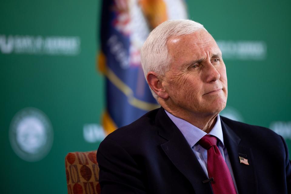 Former Vice President Mike Pence talks to journalists during an interview after speaking at an event at the Zions Bank Building in Salt Lake City.