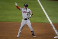 Houston Astros' Alex Bregman gestures after his two-run single during the fourth inning of the team's baseball game against the Texas Rangers in Arlington, Texas, Thursday, Sept. 16, 2021. (AP Photo/Tony Gutierrez)