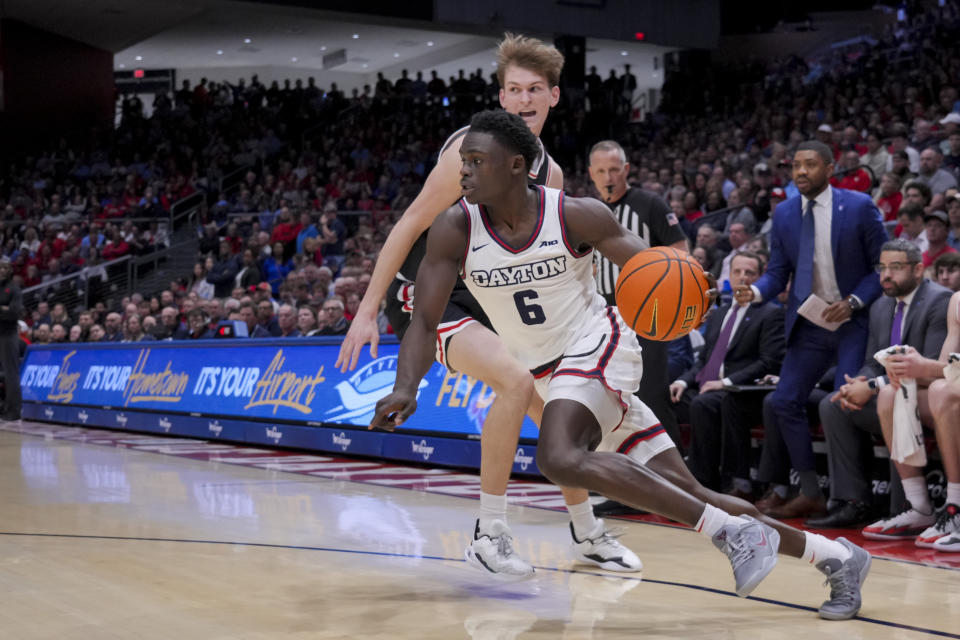 Dayton guard Enoch Cheeks, front, drives to the basket against Davidson guard Reed Bailey back, during the first half of an NCAA college basketball game, Tuesday, Feb. 27, 2024, in Dayton, Ohio. (AP Photo/Aaron Doster)