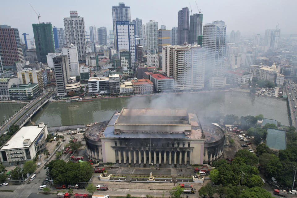 Smoke billows from the still smoldering Manila Central Post Office as a fire hits early Monday, May 22, 2023 in Manila, Philippines. A massive fire tore through Manila's historic post office building overnight, police and postal officials said Monday. (AP Photo/Aaron Favila)