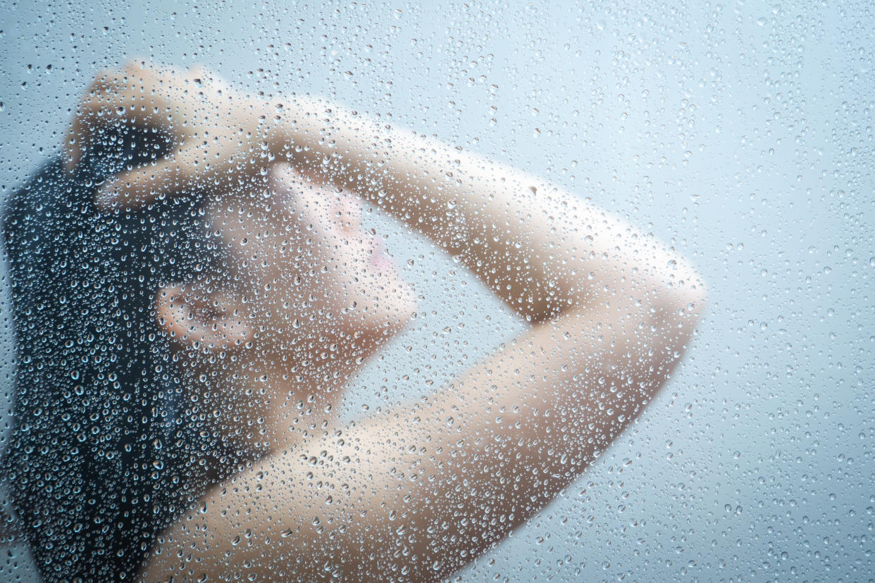 A woman showering.