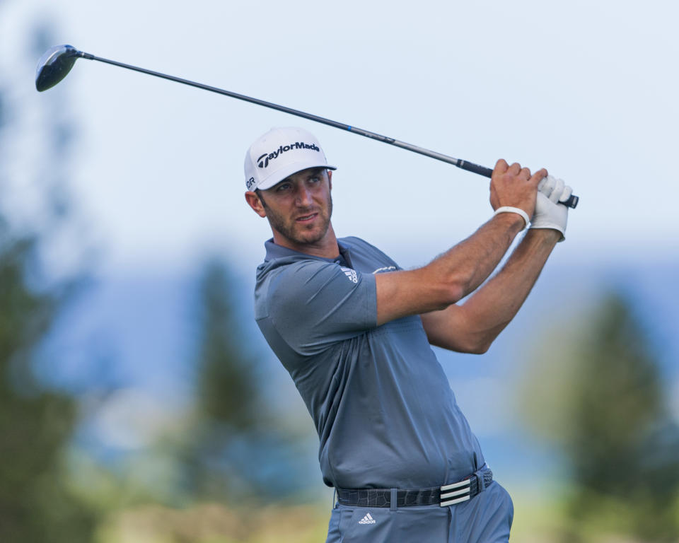 Dustin Johnson follows his drive off the ninth tee during the second round of the Tournament of Champions golf tournament, Saturday, Jan. 4, 2014, in Kapalua, Hawaii. (AP Photo/Marco Garcia)