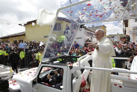 Pope Francis waves to the faithful from a popemobile in El Quinche, Ecuador, July 8, 2015. REUTERS/Guillermo Granja