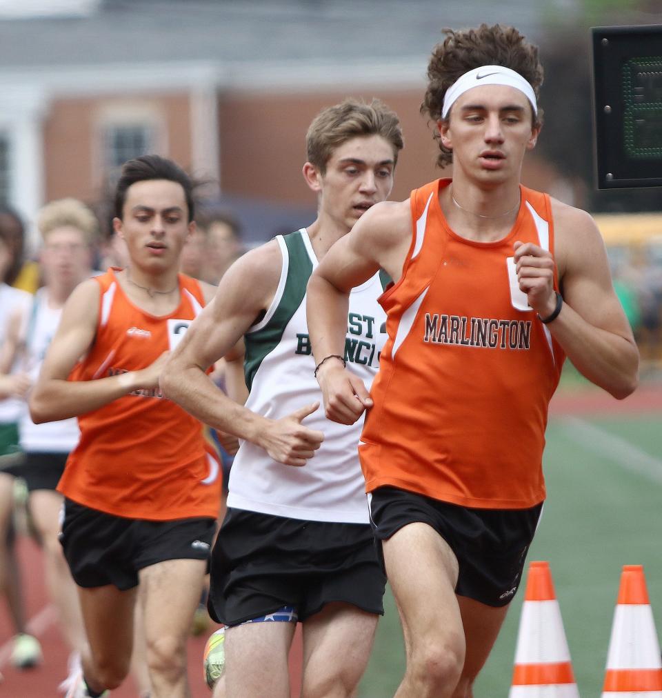 Marlington's Nash Minor, left, and Noah Graham, right, and West Branch's Josiah Hicks, center, during the boys 3200-meter final at the Division II district track and field finals at Salem Sebo Stadium on Saturday, May 21, 2022.