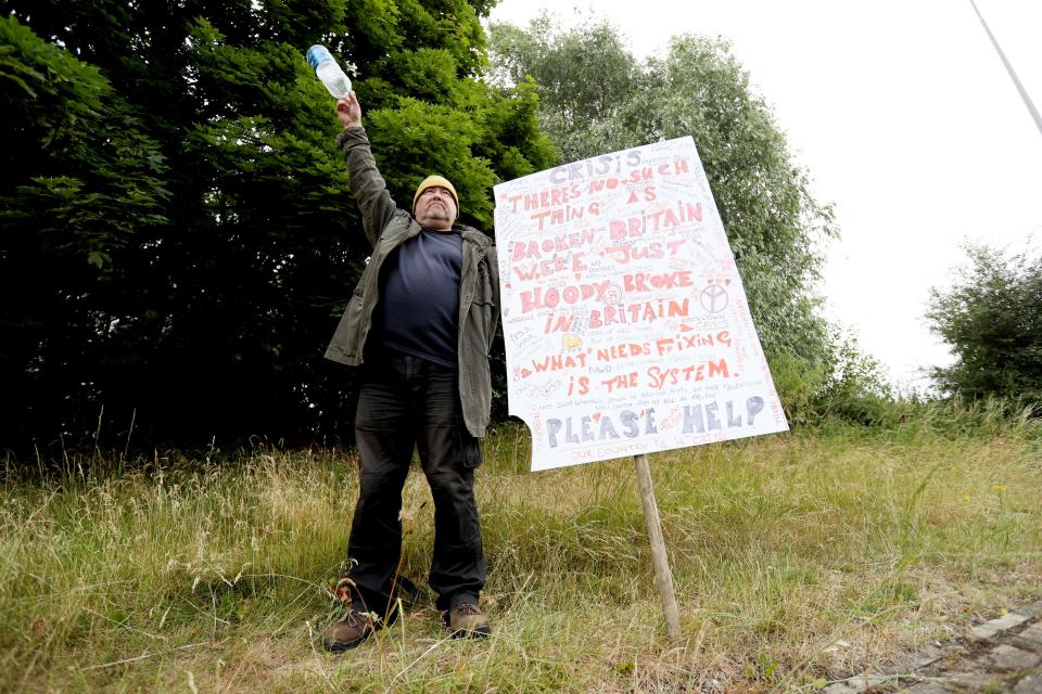 Protester holds a sign on the roundabout at Ferrybridge (Getty Images)