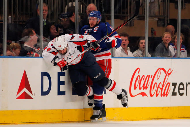 NEW YORK, NY - MAY 12: Ryan Callahan #24 of the New York Rangers checks Roman Hamrlik #44 of the Washington Capitals into the boards in Game Seven of the Eastern Conference Semifinals during the 2012 NHL Stanley Cup Playoffs at Madison Square Garden on May 12, 2012 in New York City. (Photo by Paul Bereswill/Getty Images)