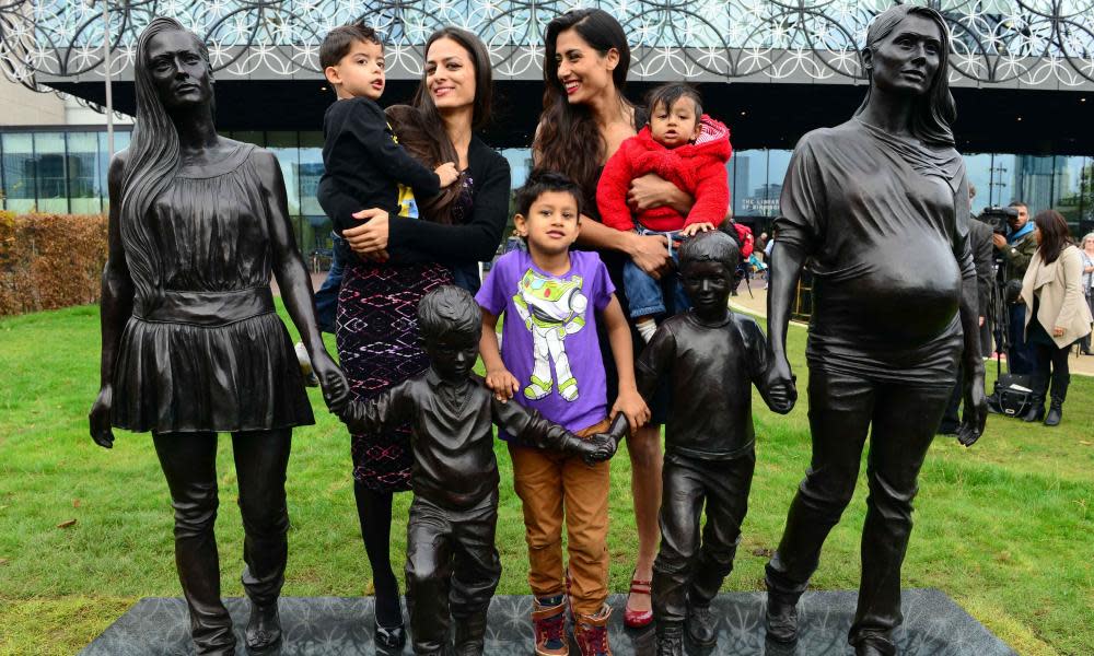 Roma Jones and her family with The Jones Family, a sculpture by Gillian Wearing in Centenary Square, Birmingham