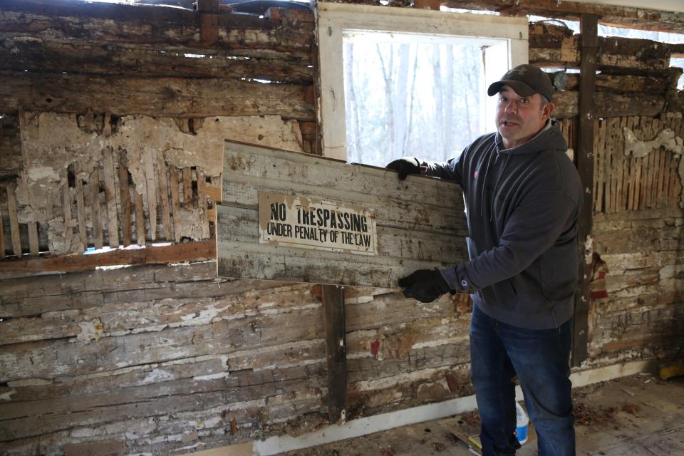 Tucker Kelley found this sign when he tore down one of the walls covering the one-room cabin. which may have been the home of a mine worker.