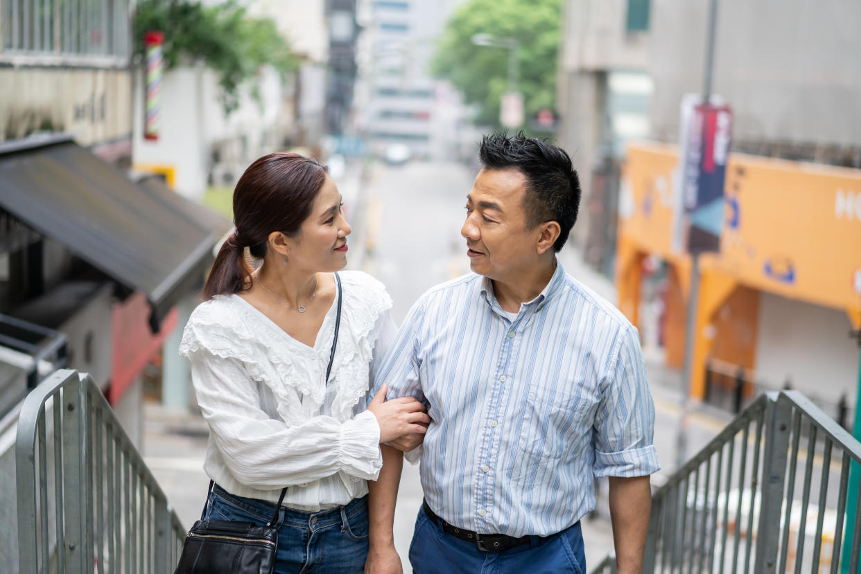 chinese couple walking at street