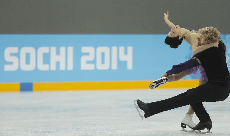 Meryl Davis and Charlie White of the United States skate at the figure skating practice rink ahead of the 2014 Winter Olympics, Wednesday, Feb. 5, 2014, in Sochi, Russia. (AP Photo/Ivan Sekretarev)