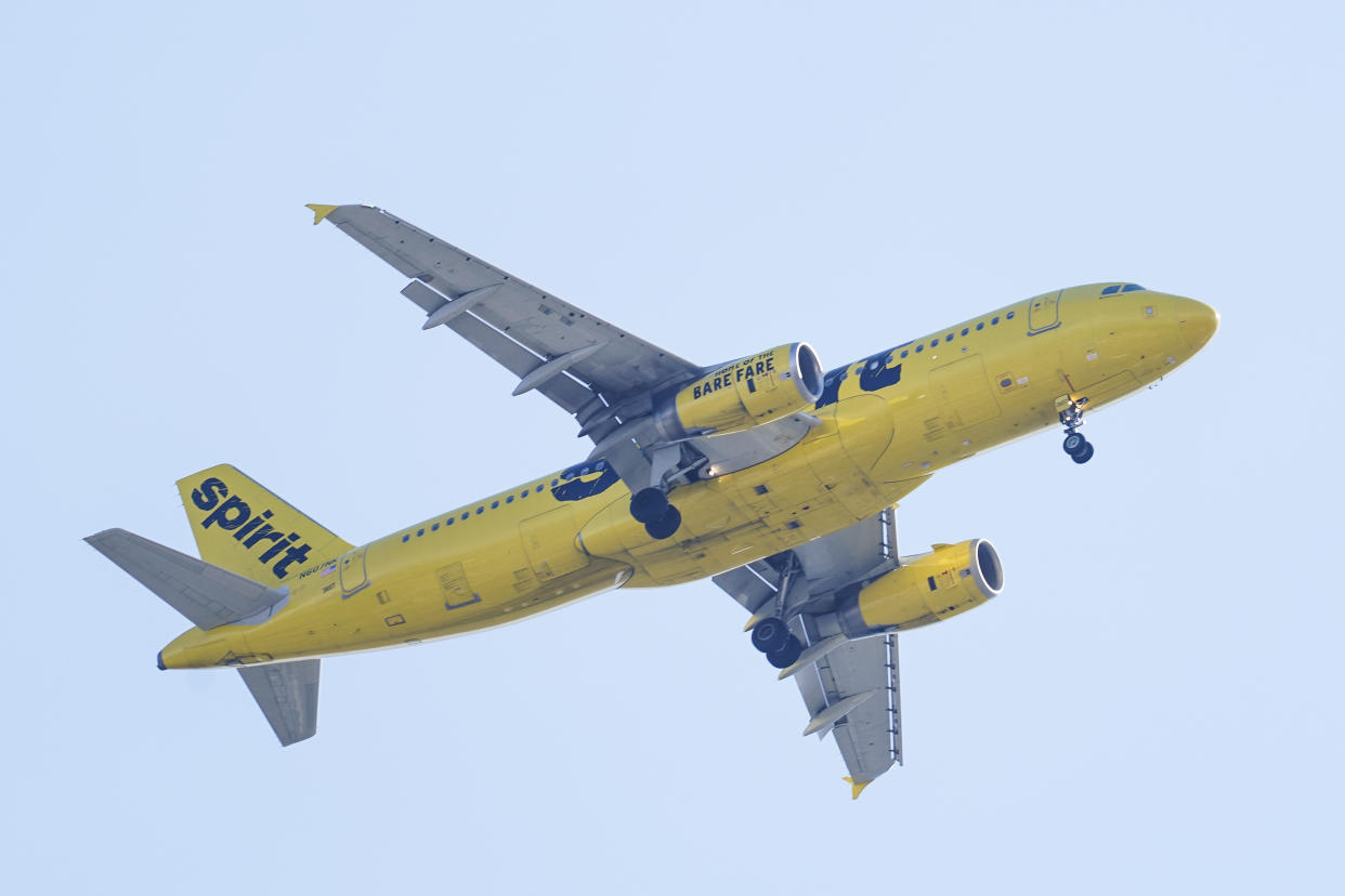 FILE - A Spirit Airline aircraft flying over Gloster City, N.J., approaches Philadelphia International Airport Friday, Oct. 22, 2021. JetBlue Airways has offered to buy Spirit Airlines for about $3.6 billion and break up a plan for Spirit to merge with rival budget carrier Frontier Airlines. Spirit said Tuesday, April 5, 2022, that its board will evaluate the JetBlue bid and decide what's best for its shareholders. (AP Photo/Matt Rourke, File)