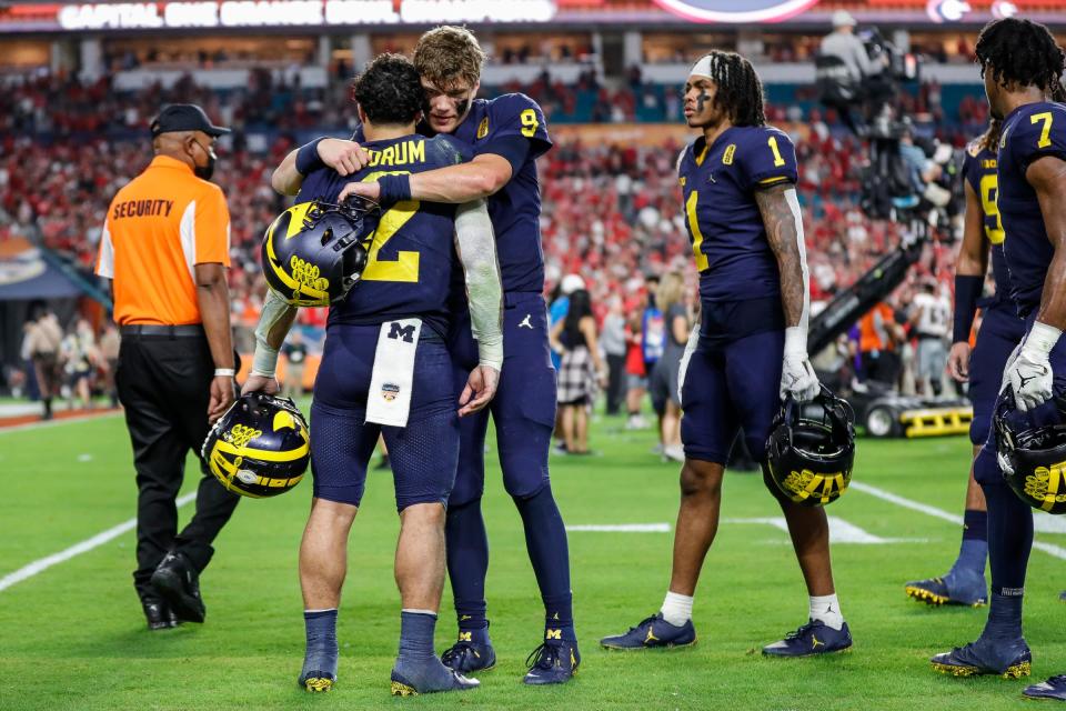 Michigan running back Blake Corum (2) is comforted by quarterback J.J. McCarthy (9) after the Wolverines lost, 34-11, to Georgia at the Orange Bowl at Hard Rock Stadium in Miami Gardens, Florida, on Friday, Dec. 31, 2021.