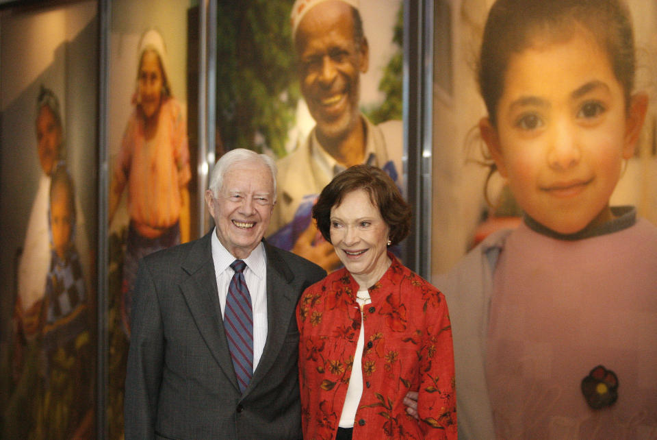 FILE - In this Sept. 28, 2009, file photo former President Jimmy Carter and his wife Rosalynn look at a new interactive exhibit at the Jimmy Carter Library and Museum in Atlanta. Jimmy Carter and his wife Rosalynn celebrate their 75th anniversary this week on Thursday, July 7, 2021. (AP Photo/John Bazemore, File)