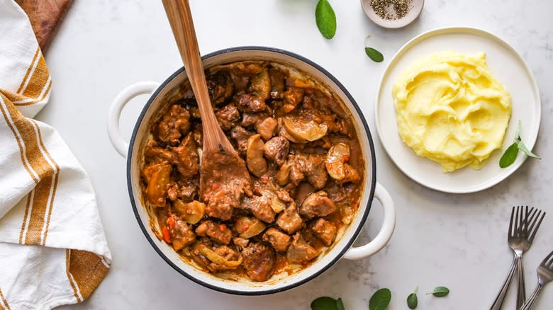 braised pork and apple casserole over mashed potatoes