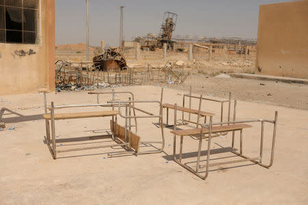 Damaged school tables are pictured in the school yard on the outskirts of Raqqa, Syria August 20, 2017. REUTERS/Zohra Bensemra