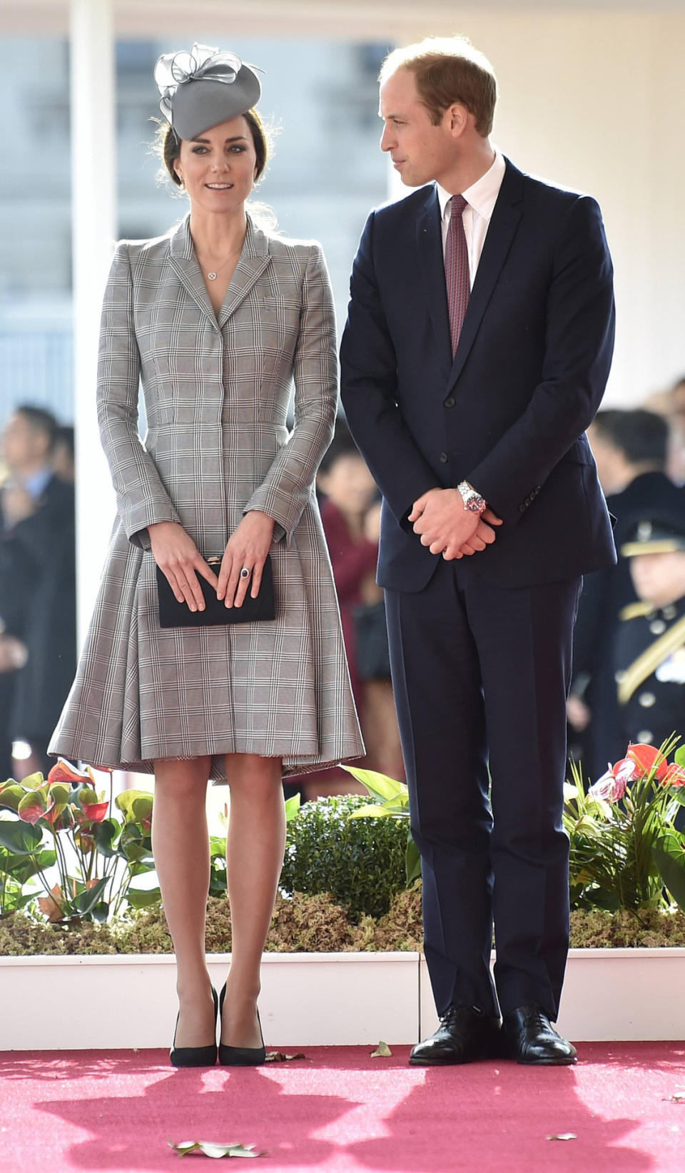 <p>Welcoming the President of Singapore, Kate chose a bespoke Alexander McQueen coat with a coordinating grey Jane Taylor hat. She carried a black suede Jenny Packham clutch and finished with Prada shoes.</p><p><i>[Photo: PA]</i></p>