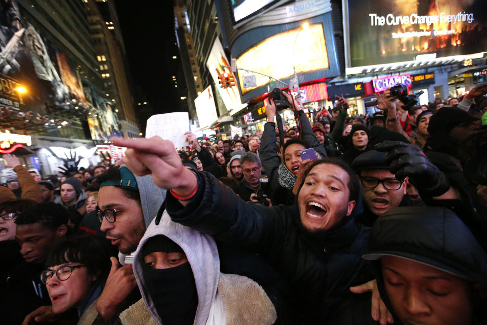 Protesters rallying against a grand jury's decision not to indict the police officer involved in the death of Eric Garner confront police as they attempt to block traffic at the intersection of 42nd Street and Seventh Avenue near Times Square, Thursday, Dec. 4, 2014, in New York. (AP Photo/Jason DeCrow)