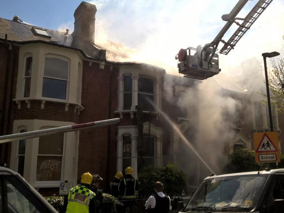 Firefighters outside a house in Stroud Green where an explosion took place on 19 April: LFB